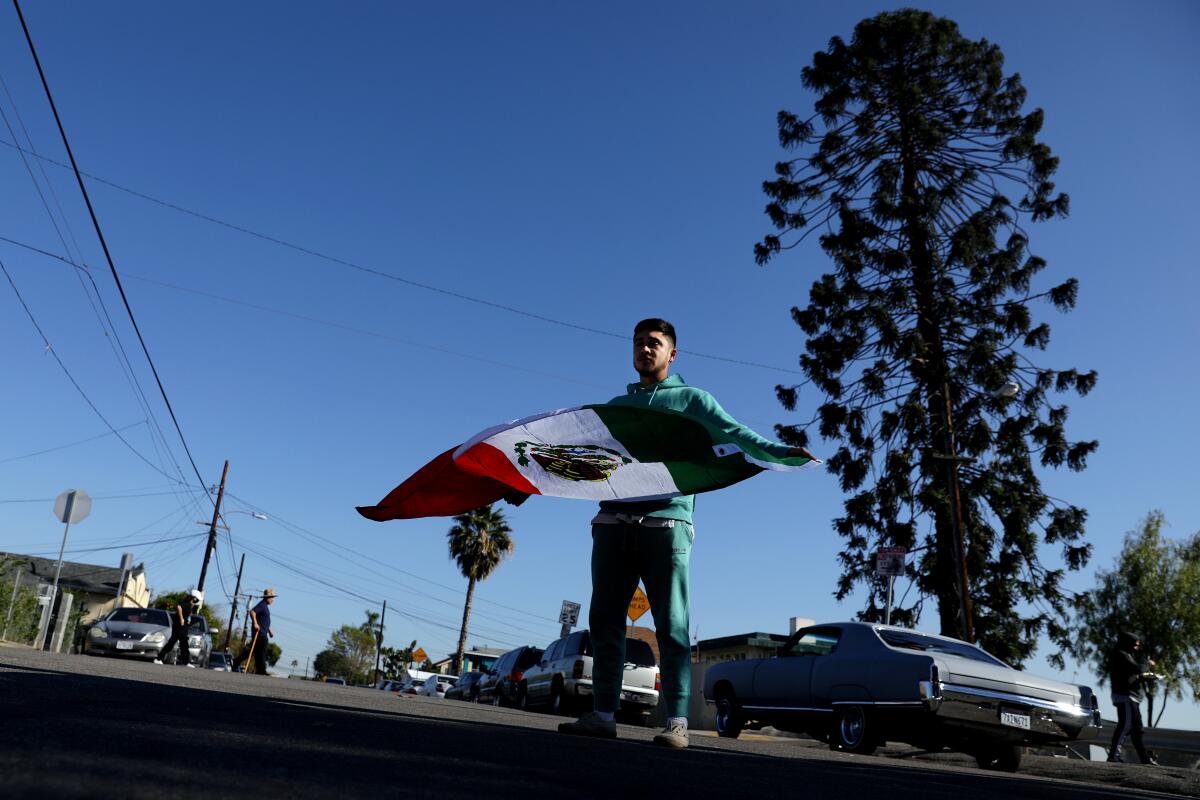 Carlos Mier, 26, has his picture taken in from of the world-famous pine tree in East Los Angeles known as "El Pino Famoso."