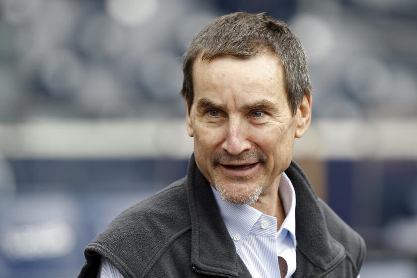 San Diego Padres owner Peter Seidler stands on the field before the team's baseball game against the Seattle Mariners 