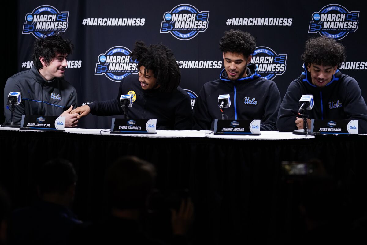 UCLA's Jaime Jaquez Jr., Tyger Campbell, Johnny Juzang and Jules Bernard react during a news conference
