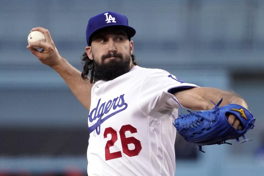 Los Angeles Dodgers starting pitcher Tony Gonsolin throws to the plate during the first inning.