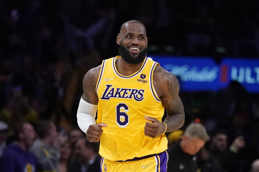 Los Angeles Lakers forward LeBron James (6) smiles during the first half of an NBA basketball game against the Golden State Warriors in Los Angeles, Saturday, March 5, 2022. (AP Photo/Ashley Landis)