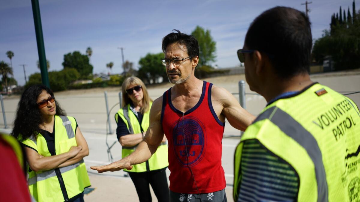 David Spangler, center, talks with volunteers at the West Valley Los Angeles River Bikeway on March 31.