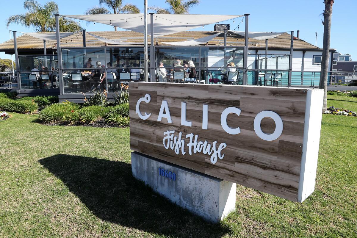 Customers enjoy their meals in the outside dining space at the recently opened Calico Fish House in Sunset Beach.