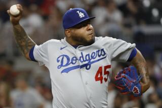 Reyes Moronta pitches for the Dodgers during the eighth inning of a baseball game against the Atlanta Braves