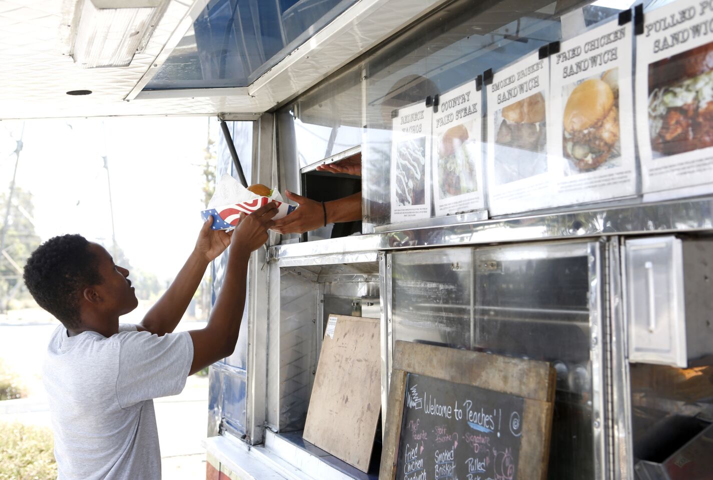 Order up! A customer is just minutes from chowing down on the truck's specialty: Southern food.