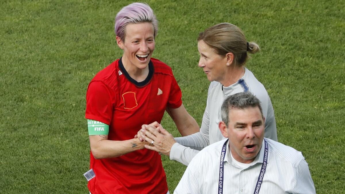 Jill Ellis celebrates with Megan Rapinoe, who scored both U.S. goals Monday against Spain.