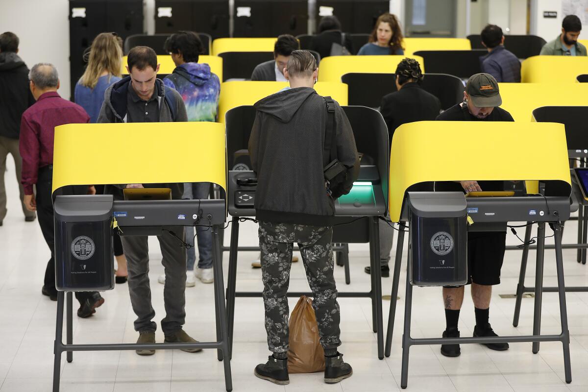 People use new voting machines in Los Angeles during the March 3 primary.
