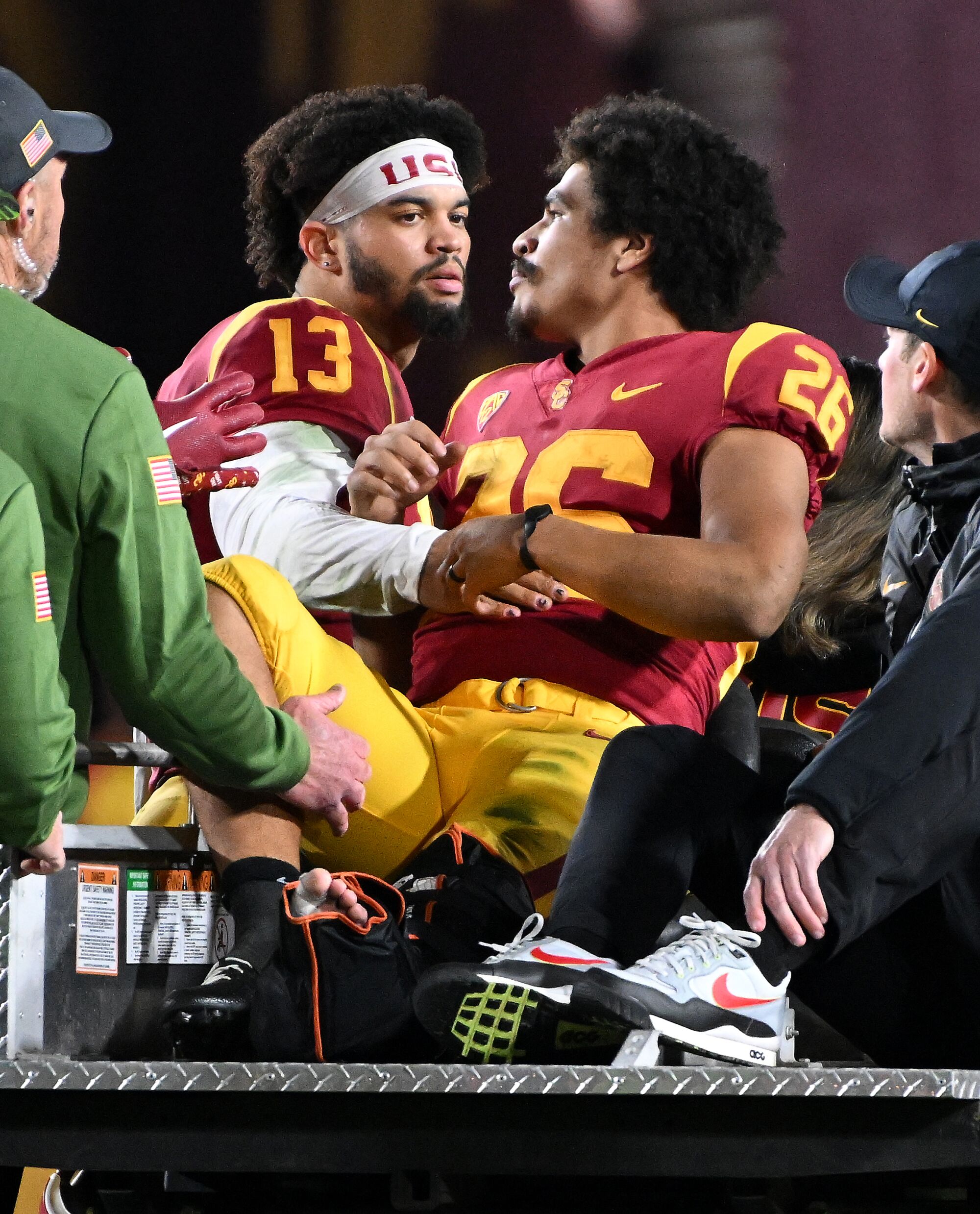 USC running back Travis Dye is consoled by quarterback Caleb Williams.