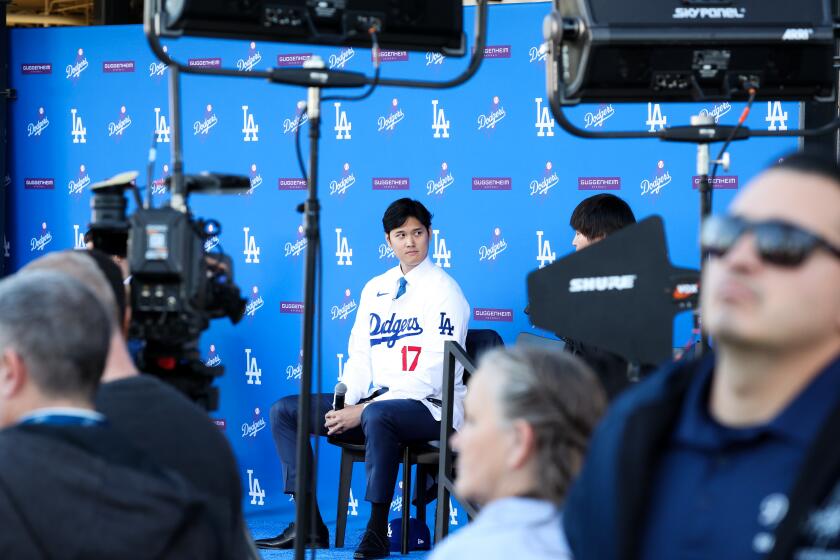 LOS ANGELES, CA - DECEMBER 14: Shohei Ohtani prepares to speak as the Los Angeles Dodgers introduce Ohtani as the newest member of the team during a press conference at Dodger Stadium in Los Angeles Thursday, Dec. 14, 2023. The Dodgers signed Ohtani to a 10-year $700 million contract on a blockbuster free agency signing. (Wally Skalij / Los Angeles Times)