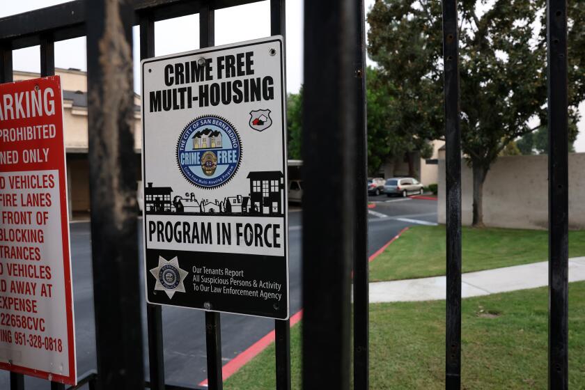 SAN BERNARDINO, CA- SEPTEMBER 15: An apartment complex at 2225 E Pumalo Street displays a crime free housing sign on the gate of their property on Tuesday, Sept. 15, 2020 in San Bernardino, CA. The signs represent the idea that landlords are encouraged or required to evict or exclude tenants who have had some level of interaction with law enforcement. (Dania Maxwell / Los Angeles Times)