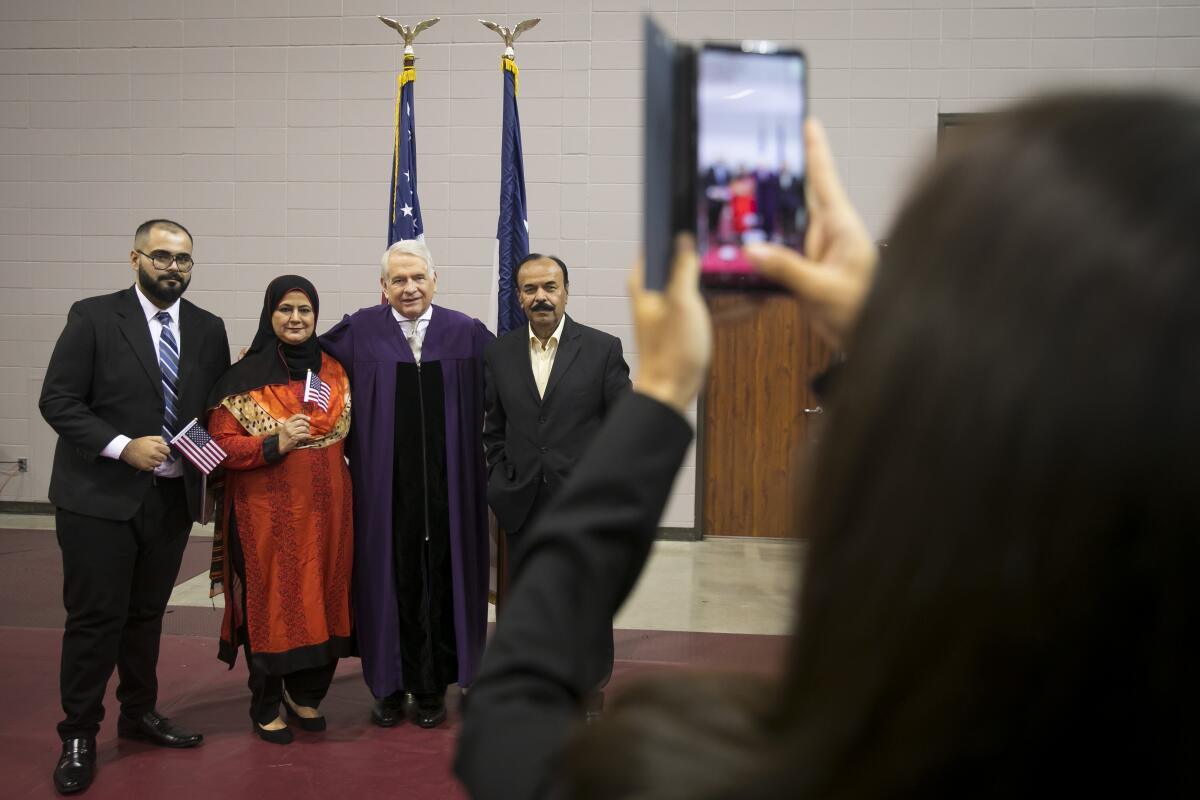 Newly naturalized citizens pose with Judge Keith P. Ellison in Houston