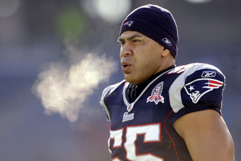 FILE - New England Patriots linebacker Junior Seau (55) warms up on the field on Jan. 10, 2010, before an NFL wild-card playoff football game in Foxborough, Mass. NFL player turned broadcaster Ross Tucker will wear shoes showing an image of a traumatized brain and a portrait of Seau to raise money for the families of players who suffered from chronic traumatic encephalopathy. (AP Photo/Charles Krupa, File)