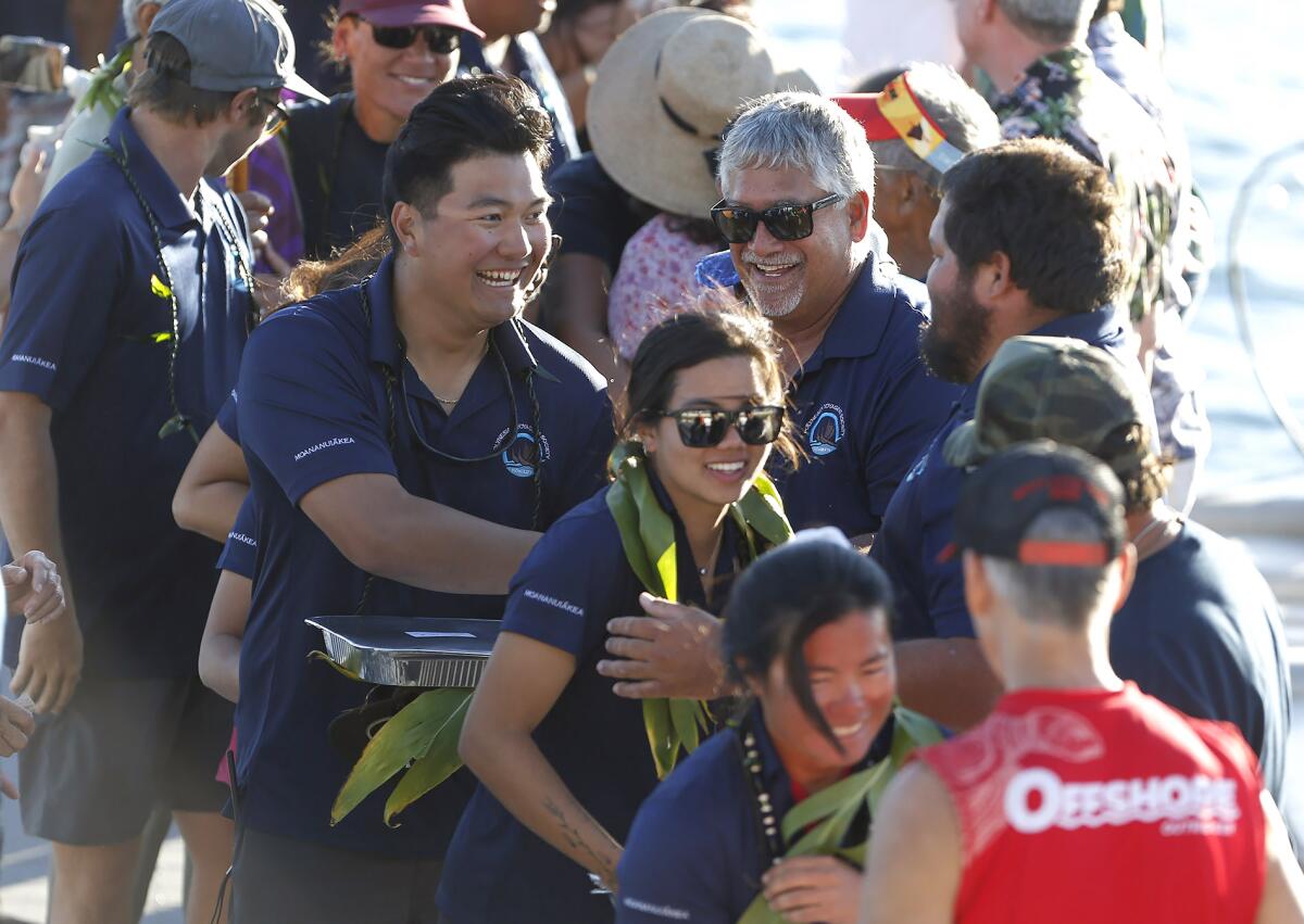 Members of the crew of the Hokule‘a, including Tamiko Fernelius, bottom, and Jonah Apo, top left, are greeted.