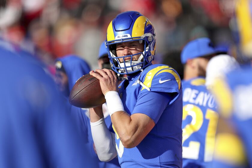 Los Angeles Rams quarterback Matthew Stafford (9) warms up on the sideline during a NFL divisional playoff football game between the Los Angeles Rams and Tampa Bay Buccaneers, Sunday, January 23, 2022 in Tampa, Fla. (AP Photo/Alex Menendez)