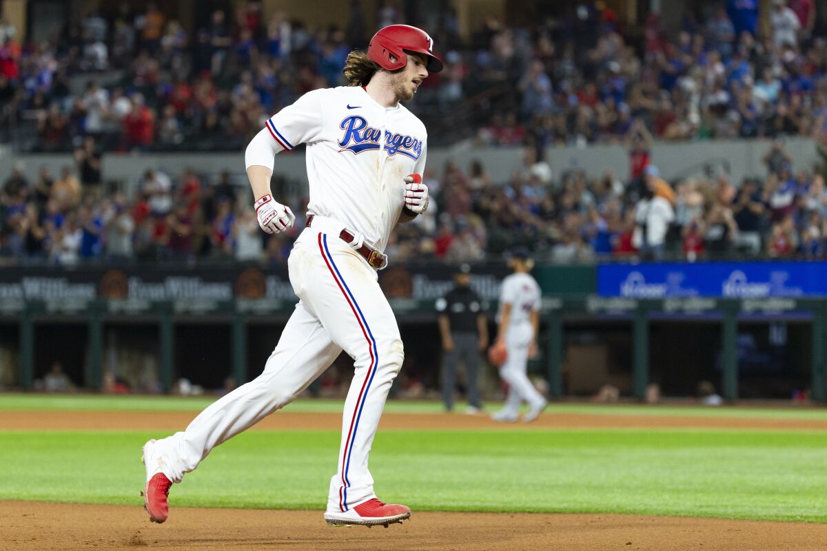 Texas Rangers' Jonah Heim runs the bases after hitting a three-run home run during the fourth inning of a baseball game against the Cleveland Indians, Saturday, Oct. 2, 2021, in Arlington, Texas. Nate Lowe and Andy Ibanez scored on the hit. (AP Photo/Sam Hodde)