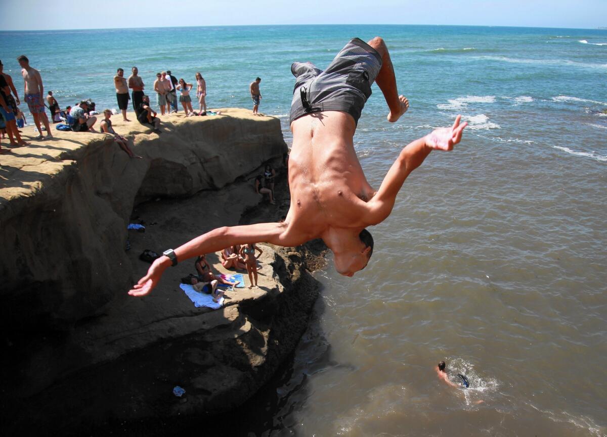 Jake O'Connell, 19, does a front flip at Sunset Cliffs.