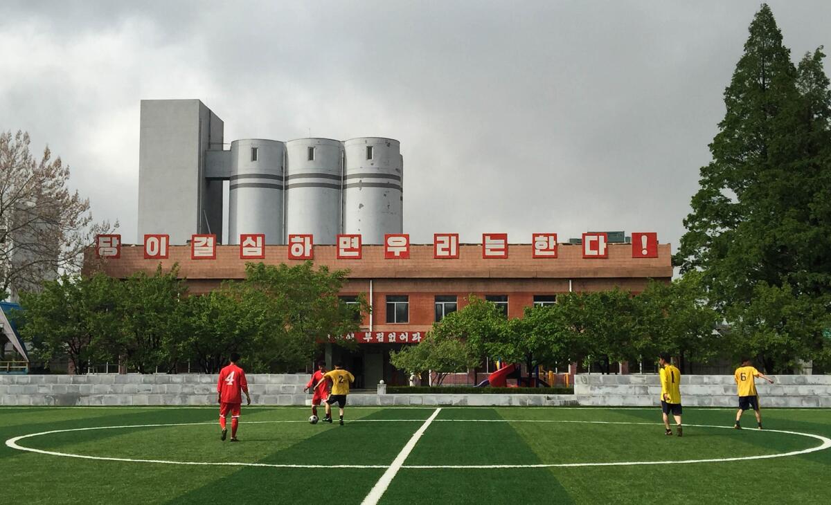 The well-manicured soccer field in front of the wire factory. Men were playing soccer at 2 p.m. in the afternoon, though it was a workday. (Julie Makinen / Los Angeles Times)