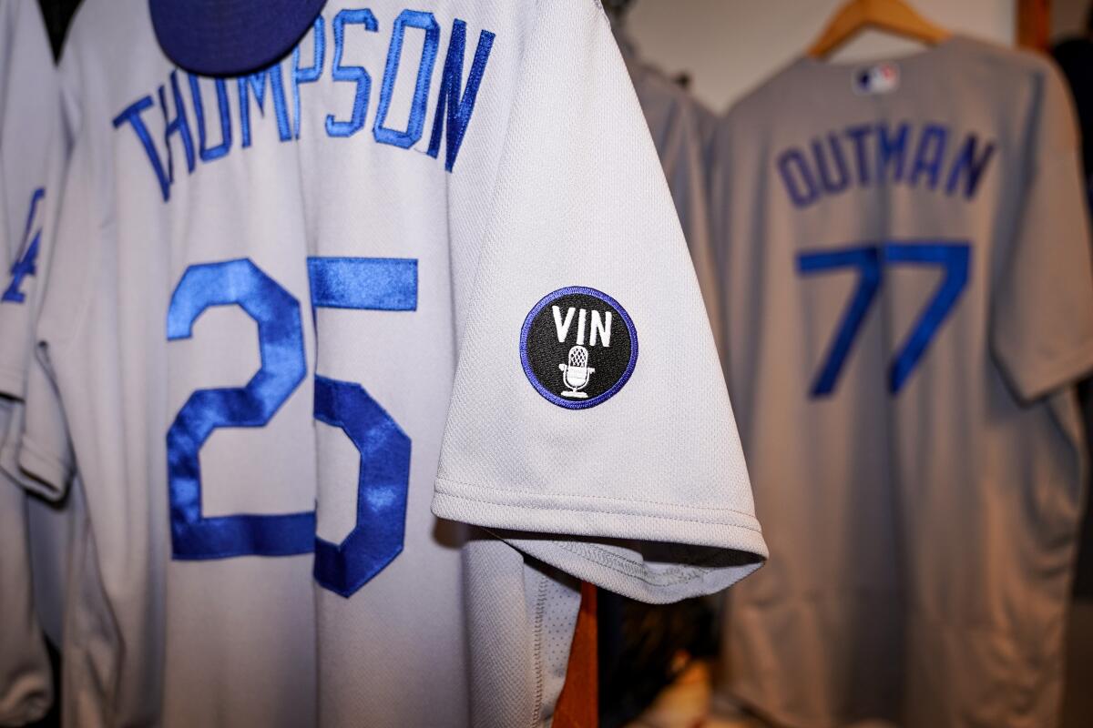The Dodgers will honor Vin Scully with a black jersey patch featuring the word "Vin" and a microphone.