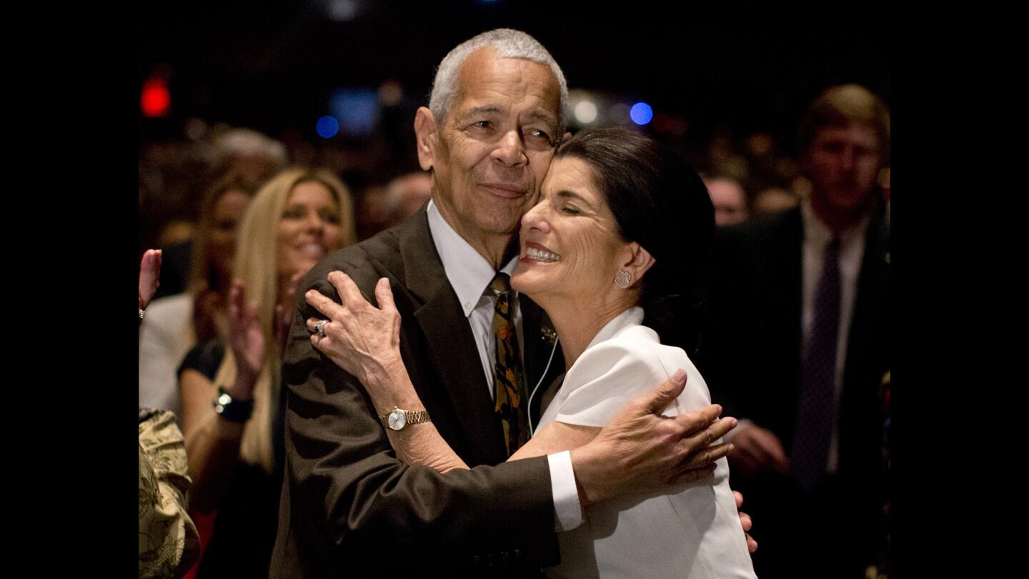 Julian Bond hugs Luci Baines Johnson, the younger daughter of President Lyndon B. Johnson, during an April 10, 2014, event in Austin, Texas, to commemorate the 50th anniversary of the signing of the Civil Rights Act.