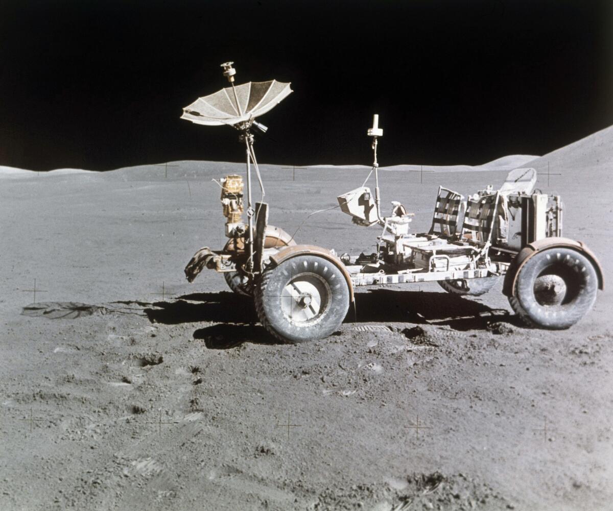 FILE - Rover alone, looking north, on the west edge of Mount Hadley is at upper right edge of picture, the most distant lunar feature visible is about 25 kilometers away, Aug. 1971. Goodyear is teaming with Lockheed Martin on the development of a vehicle planned for use on the moon, providing airless tires for the project. This isn't Goodyear's first venture into space, as it supplied essential products for NASA's Apollo program, including the Apollo 11 mission. (AP Photo, File)