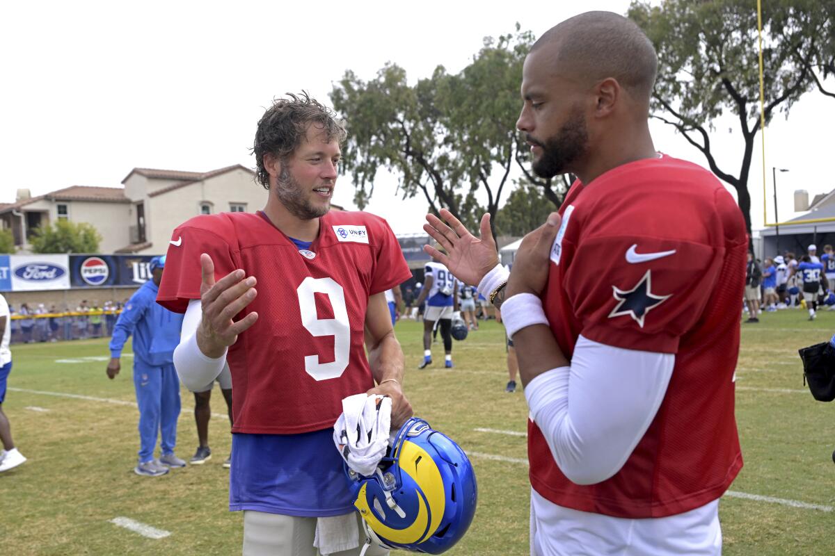 Rams quarterback Matthew Stafford (9) greets Cowboys quarterback Dak Prescott after their joint practice in Oxnard.