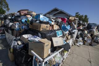LOS ANGELES, CA - November 03 2021: A home in Koreatown is piled with belongings of a homeowner at 158 S. Harvard Blvd. in on Wednesday, Nov. 3, 2021 in Los Angeles, CA. (Brian van der Brug / Los Angeles Times)