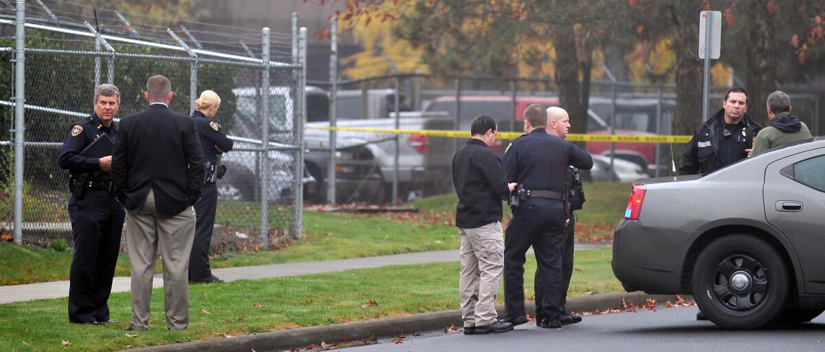 Officials work the scene after an explosion shattered windows and damaged buildings around the Jackson County district attorney's office in Medford, Ore.