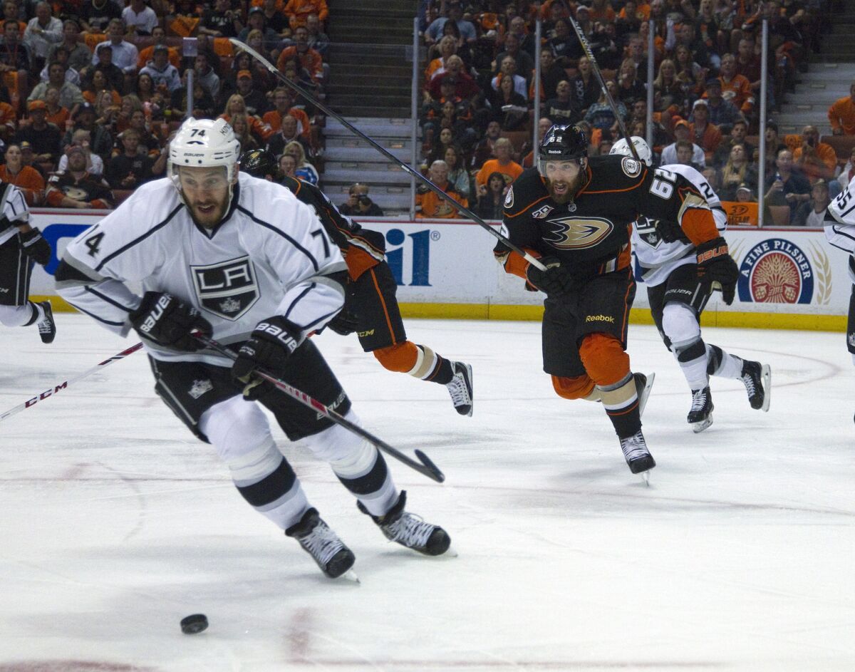 Kings left wing Dwight King (74) charges after a loose puck with Ducks left wing Patrick Maroon (62) giving chase in Game 5 of the Western Conference semifinal series on Monday.