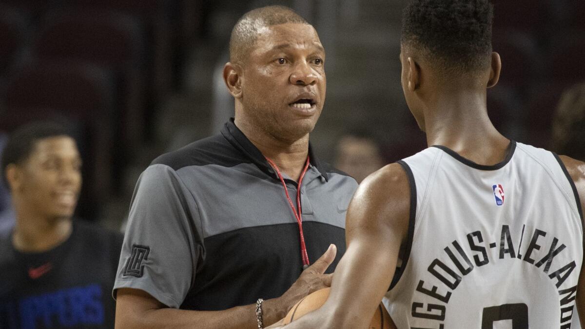 Clippers coach Doc Rivers talks to point guard Shai Gilgeous-Alexander during a practice session.