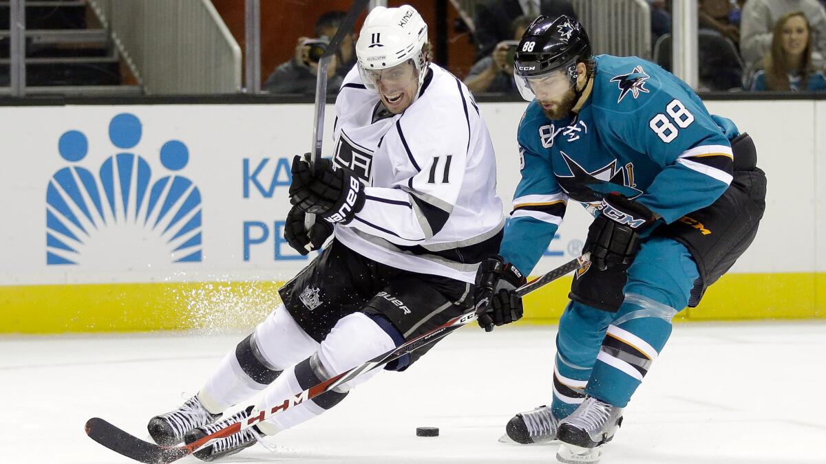 Kings center Anze Kopitar, left, battles San Jose Sharks forward Brent Burns for the puck during an exhibition game Tuesday.