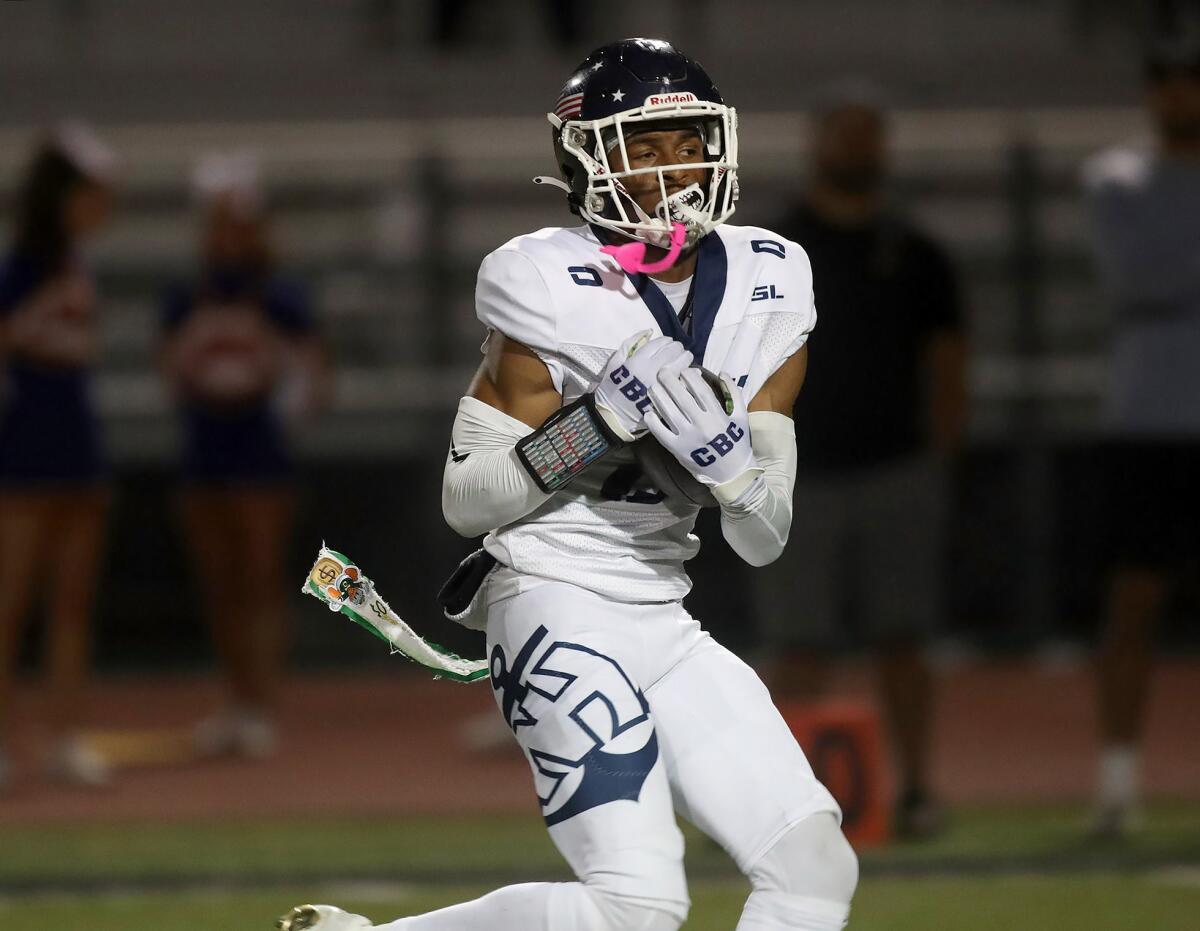 Newport Harbor receiver Jordan Anderson secures a long throw from quarterback Jaden O'Neal on Friday.