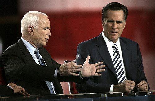 John McCain, left, and Mitt Romney tangle in one of their many confrontations during the debate. At one point, an irritated Mike Huckabee, who is running a distant third place in the GOP contest, interjected: "I didn't come here to umpire a ballgame between these two. I came here to get a chance to swing at a few myself."