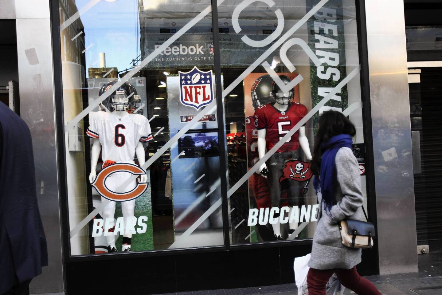 A window display in a Reebok store on Oxford Street hypes upcoming Chicago Bears' game against the Tampa Bay Buccaneers by showing highlights of the 1985 Super Bowl champs and Jay Cutler and Josh Freeman uniforms in London, England.