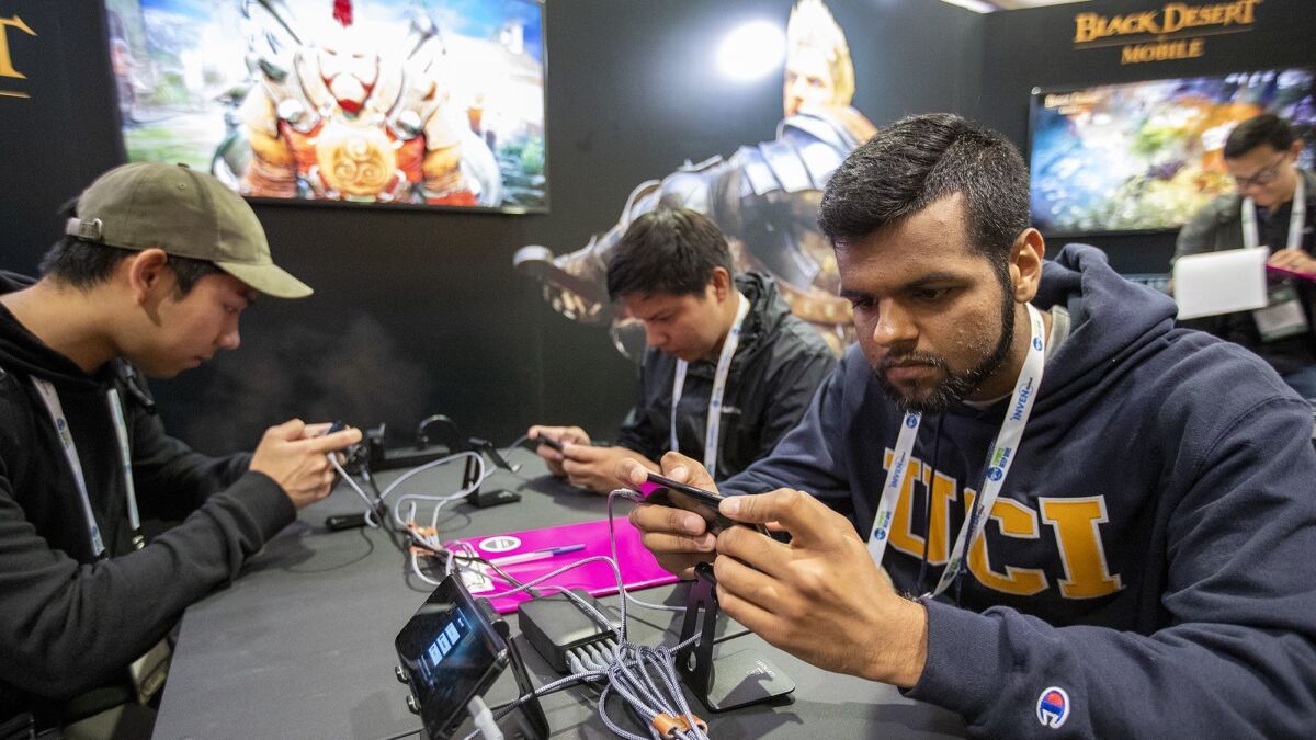 Hamzah Hameed, right, plays Black Desert Online during the Inven Global Esports Deep Dive conference at UCI on May 1.