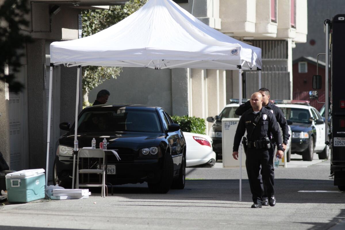 LAPD officials investigate the apartment building where a Chinese graduate student at USC was found dead after an apparent beating.