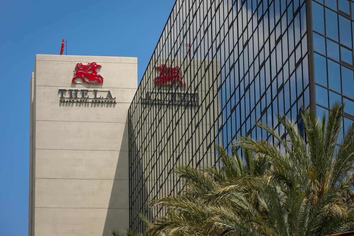 Glass facade with a building in the background that says L.A. Grand.