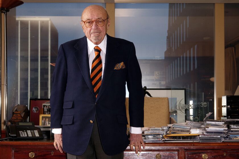 **FILE** Ahmet Ertegun poses in his office at Atlantic Records in New York, in this file photo from Feb. 2, 2005. Ertegun, who helped define American music as the founder of Atlantic Records, a label that popularized the gritty R&B of Ray Charles, the classic soul of Aretha Franklin and the British rock of the Rolling Stones, has died, Thursday Dec. 14, 2006, his spokesman said. He was 83. (AP Photo/Jim Cooper,File)