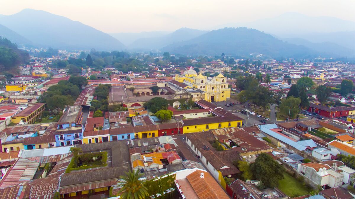 Elevated view of Antigua, Guatemala, at twilight. Antigua is a partially restored colonial city with majestic churches and monasteries and cobblestone streets.