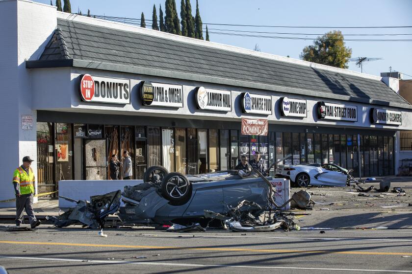 VAN NUYS, CA-FEBRUARY 8, 2023:Overall shows the scene of a crash involving a Honda Accord, left, and a Chevy Corvette, background, that ended up in a shopping center after crashing into a Honda Accord at the intersection of Balboa Blvd. and Victory Blvd. in Van Nuys. According to LAPD Sgt. Hector Gutierrez, at approximately 3:45 am this morning, the driver of the Corvette, a male, was traveling an estimated 90 to 100 mph, heading north on Balboa Blvd. and crashed into a Honda Accord, driven by a woman in her forties, traveling east on Victory Blvd. Both drivers of the cars died as a result. It is believed that the driver of the Corvette went through a red light. The passenger in the Corvette, a male, was taken to a hospital with severe injuries. There were no passengers in the Honda Accord. (Mel Melcon / Los Angeles Times)