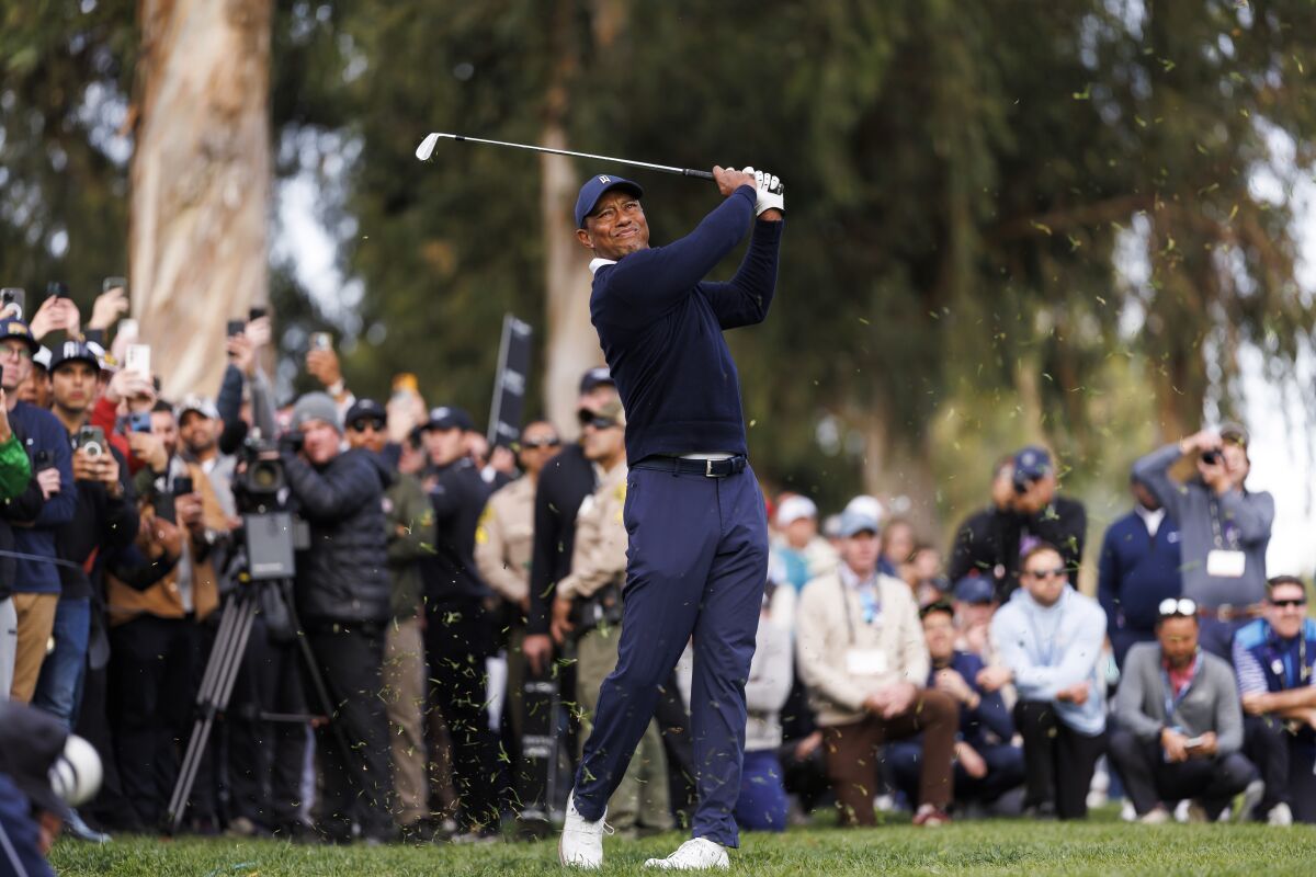 FILE - Tiger Woods hits his second shot on the 13th hole during the first round of the Genesis Invitational golf tournament at Riviera Country Club, Feb. 16, 2023, in the Pacific Palisades area of Los Angeles. Fans now flock to Woods wondering if it might be their last chance. (AP Photo/Ryan Kang, File)