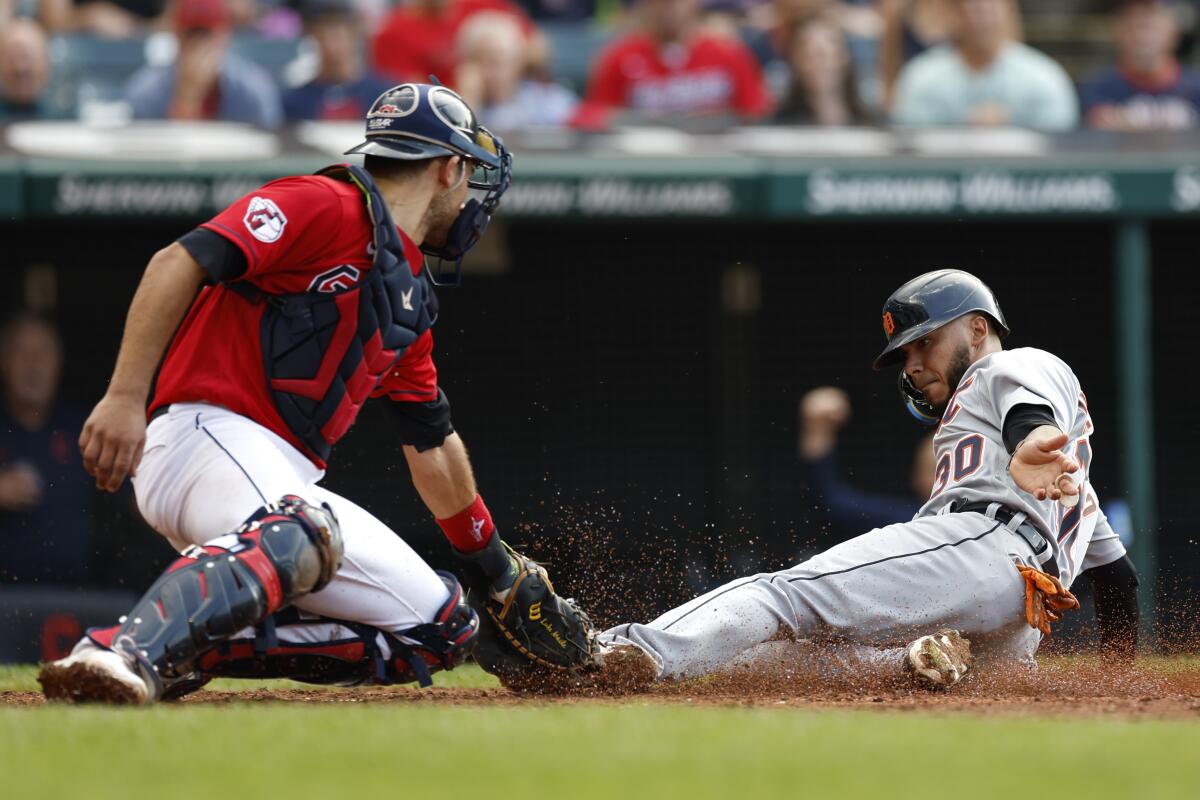 Cleveland Guardians' Luke Maile, left, tags out Detroit Tigers' Harold Castro during the ninth inning of a baseball game Saturday, July 16, 2022, in Cleveland. (AP Photo/Ron Schwane)