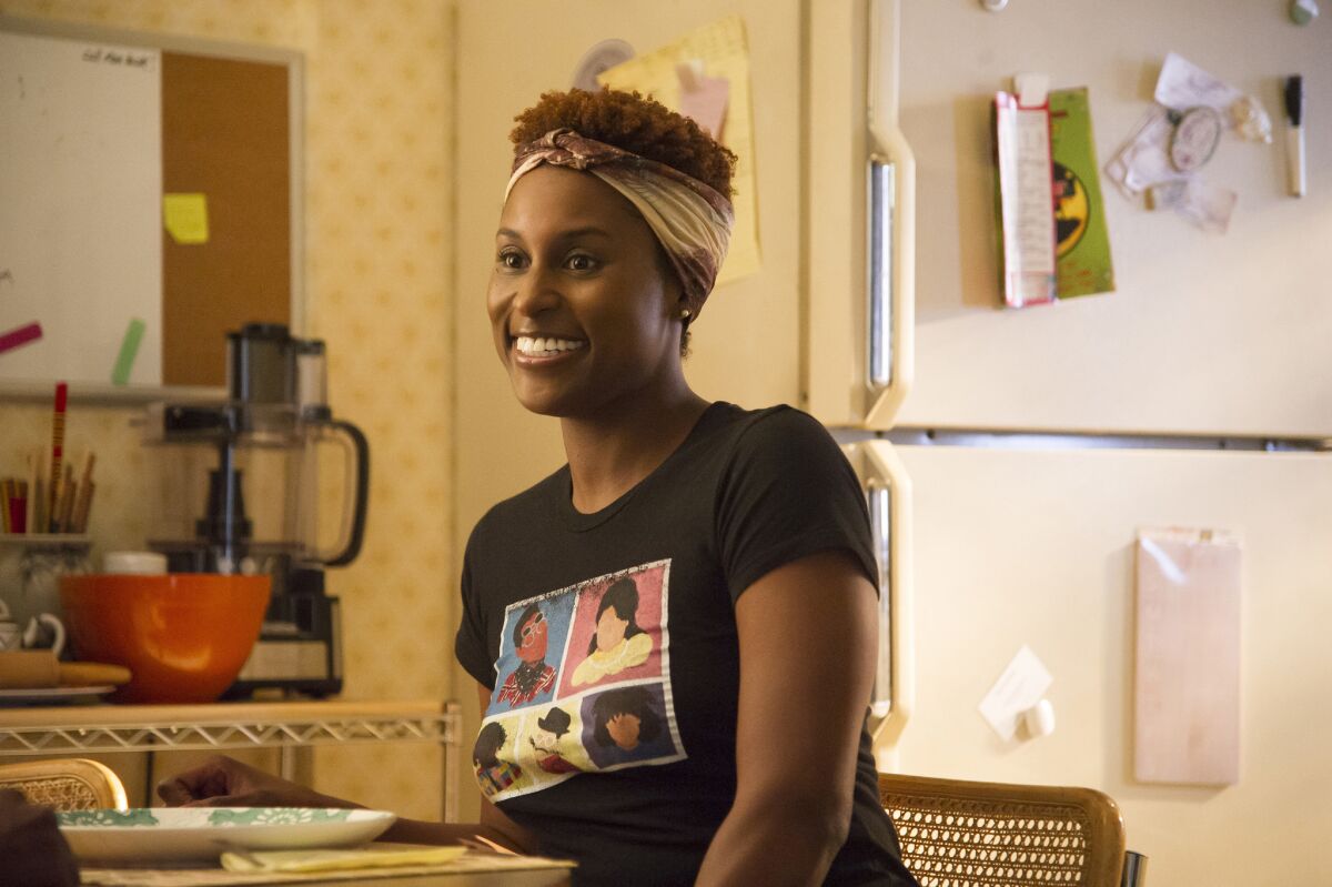 Issa Rae smiles in her kitchen in an episode of "Insecure"