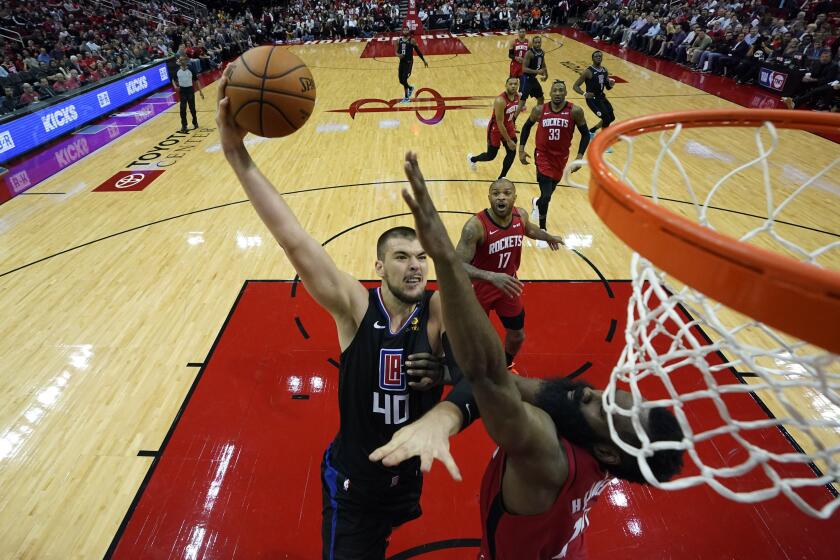 Los Angeles Clippers' Ivica Zubac (40) goes up for a shot as Houston Rockets' James Harden defends during the second half of an NBA basketball game Thursday, March 5, 2020, in Houston. (AP Photo/David J. Phillip)