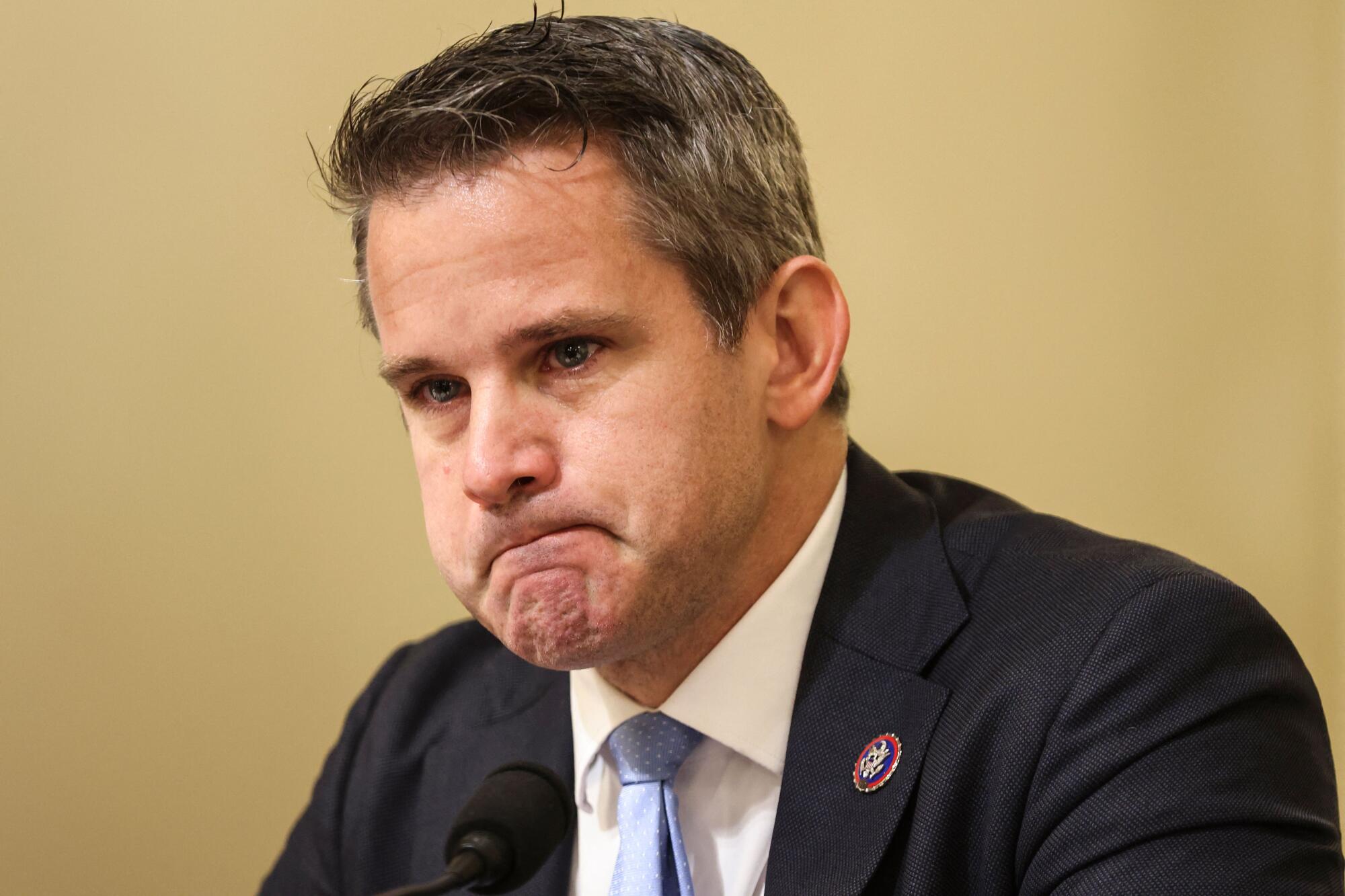 Rep. Adam Kinzinger becomes emotional.