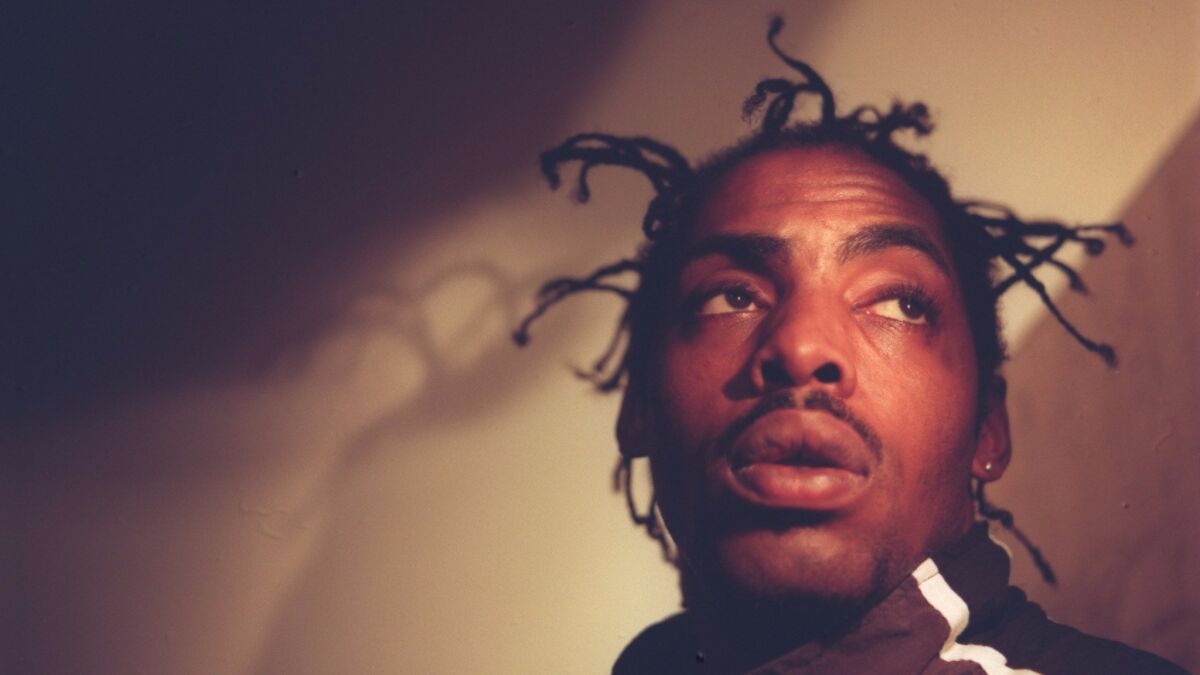 Rap artist Coolio, shown in a 1996 photo, was charged Thursday with bringing a gun to Los Angeles International Airport.