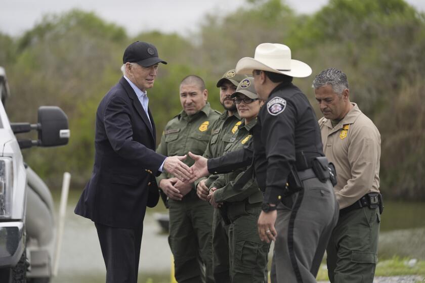 FILE - President Joe Biden talks with the U.S. Border Patrol and local officials, as he looks over the southern border, Feb. 29, 2024, in Brownsville, Texas, along the Rio Grande. Biden's migration order aims to shut down asylum requests at US-Mexico border if illegal crossings average 2,500 per day. (AP Photo/Evan Vucci, File)