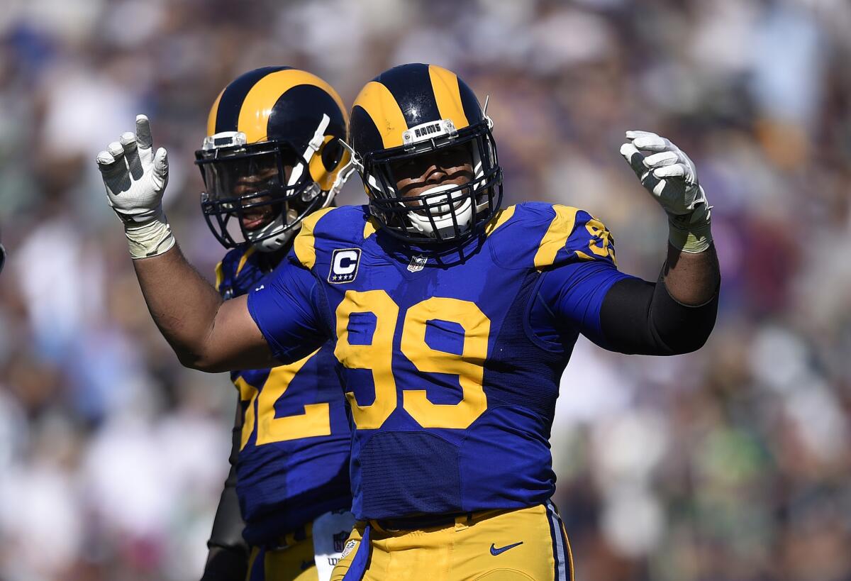 Rams' Aaron Donald tries to fire up the crowd during a game against Seattle at the Coliseum on Sept. 18.