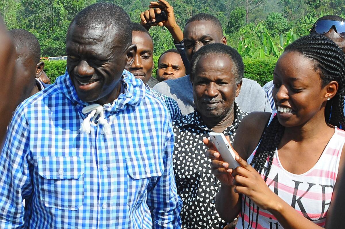 Ugandan opposition leader Kizza Besigye meets his supporters after casting his vote. He was briefly detained by authorities.