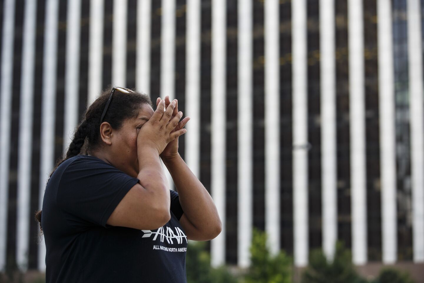 A woman weeps at a memorial outside the crime scene where 5 police officers were killed and 7 more wounded, in Dallas, Texas.