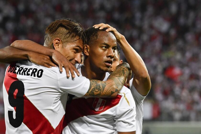 Peru's Paolo Guerrero, and Andre Carrillo, from left, react after Guerrero scored during a friendly soccer match between Saudi Arabia and Peru in kybunpark stadium, St. Gallen, Switzerland, on Sunday, June 3, 2018. (Gian Ehrenzeller/Keystone via AP)